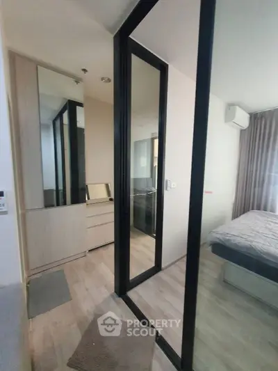 Modern bedroom with mirrored wardrobe and sleek design