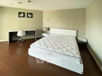 Spacious modern bedroom with minimalist design and elegant furnishings.