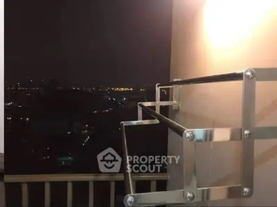 Stunning night city view from a modern balcony with sleek railing design.