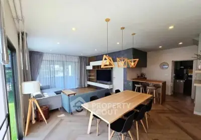 Spacious modern living room with open kitchen and stylish lighting