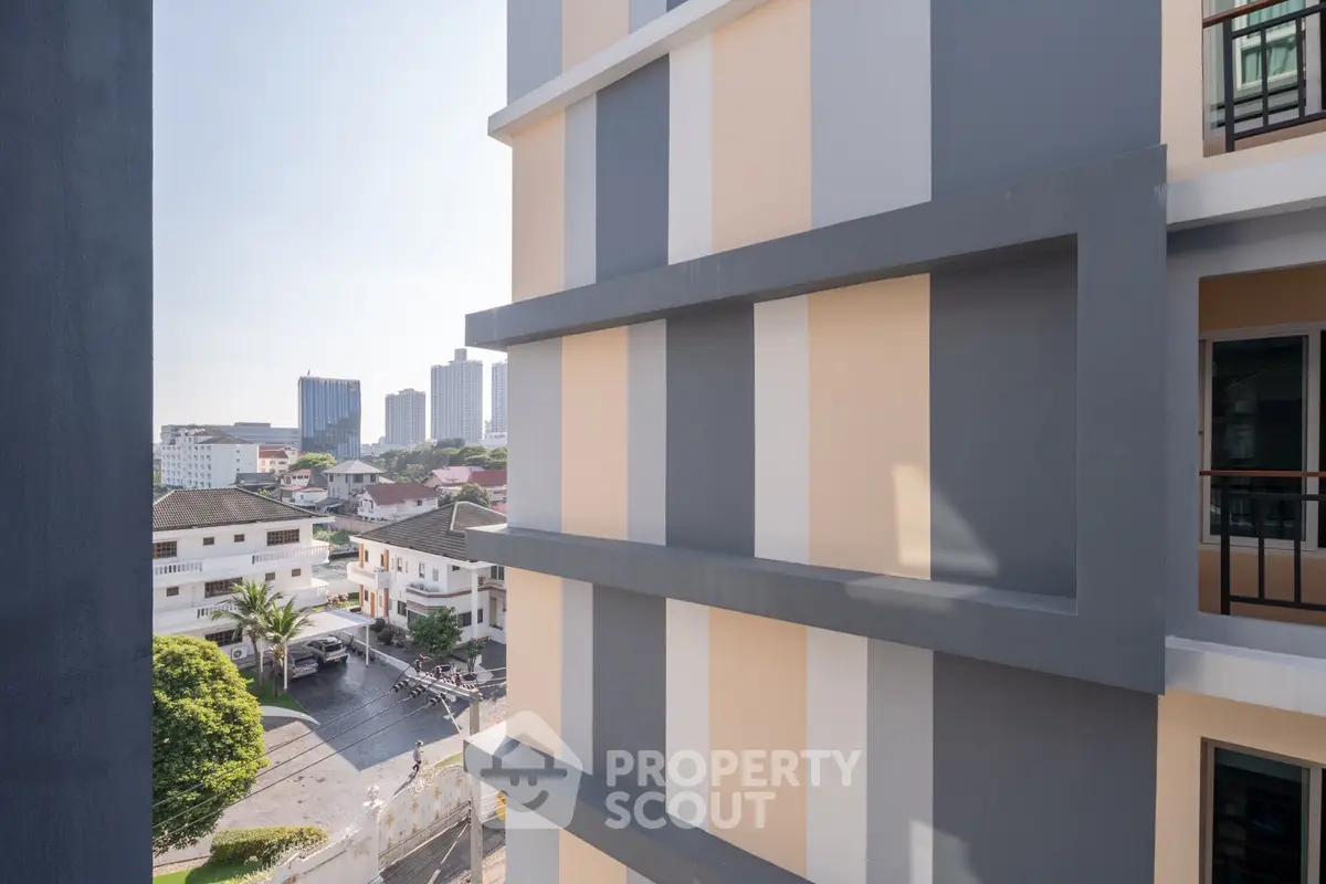 Modern apartment building exterior with city view, showcasing urban living and architectural design.