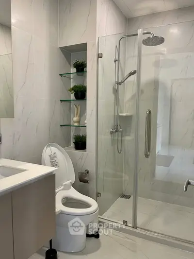 Modern bathroom with glass shower and sleek fixtures in a stylish home