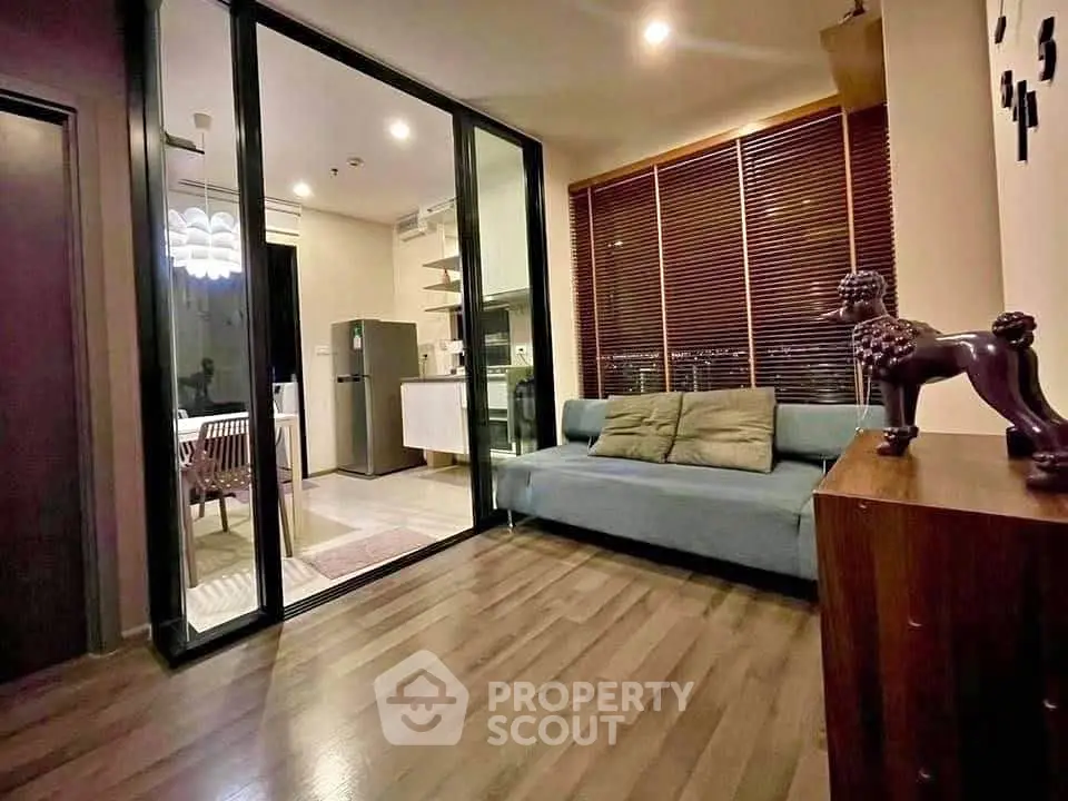 Modern living room with glass partition and stylish decor in urban apartment