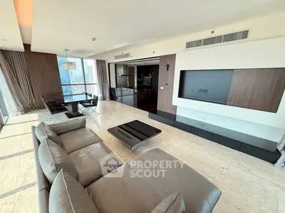 Luxurious modern living room with panoramic city views and sleek leather furniture.