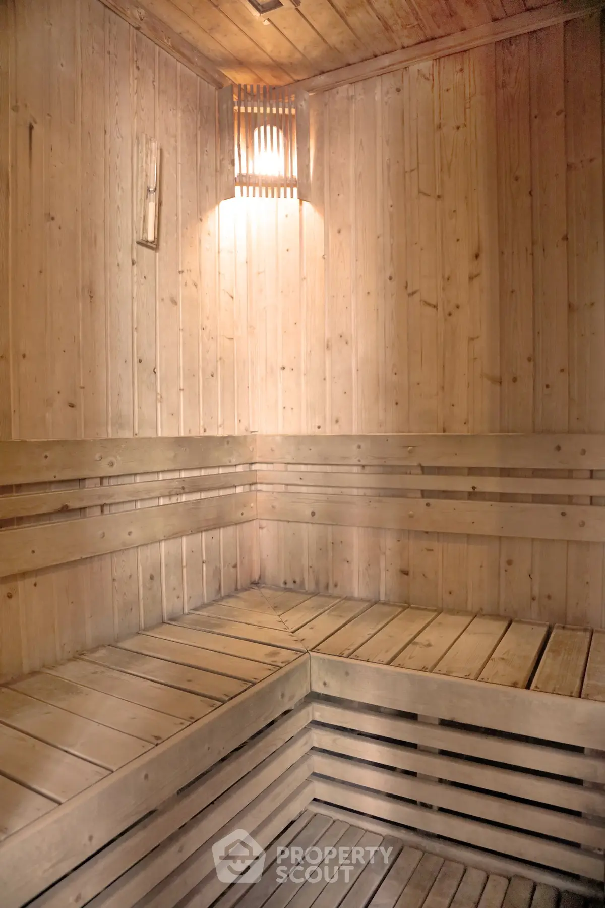 Luxurious wooden sauna room with warm lighting and elegant design, perfect for relaxation and wellness.