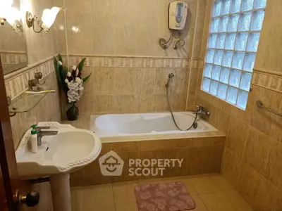 Spacious bathroom with elegant bathtub and modern fixtures in a stylish home.
