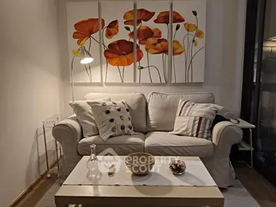 Cozy living room with stylish sofa and vibrant floral artwork, perfect for relaxation and comfort.
