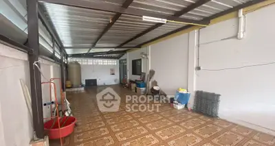 Spacious covered storage area with tiled flooring and ample natural light.