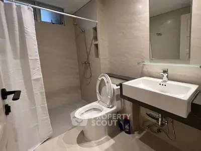 Modern bathroom with sleek fixtures and walk-in shower in a contemporary home.