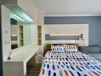 Modern bedroom with stylish decor and cozy bedding in a chic apartment.