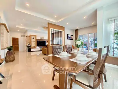 Spacious modern dining and living area with elegant decor and natural light.