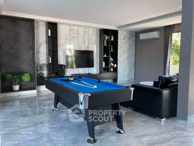Luxurious living room with pool table and modern decor