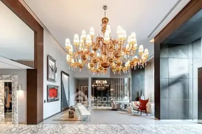Luxurious living room with grand chandelier and elegant marble flooring