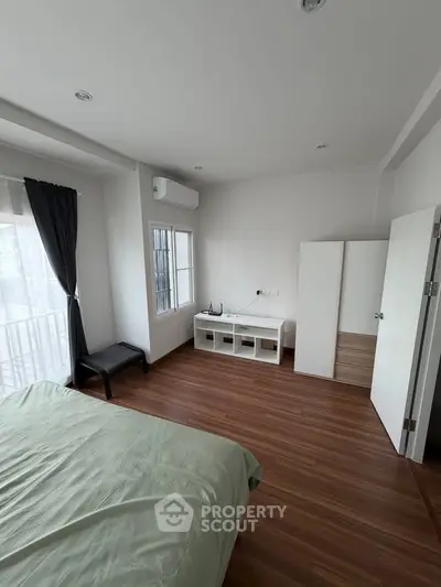 Spacious bedroom with modern decor and natural light