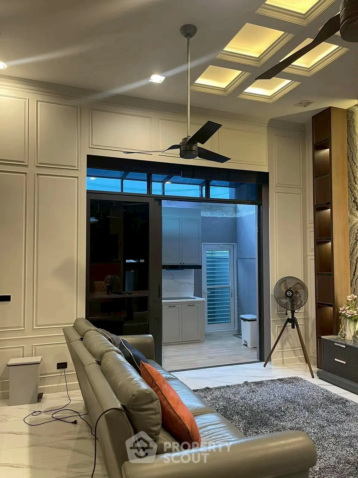 Luxurious living room with modern ceiling fan and stylish decor