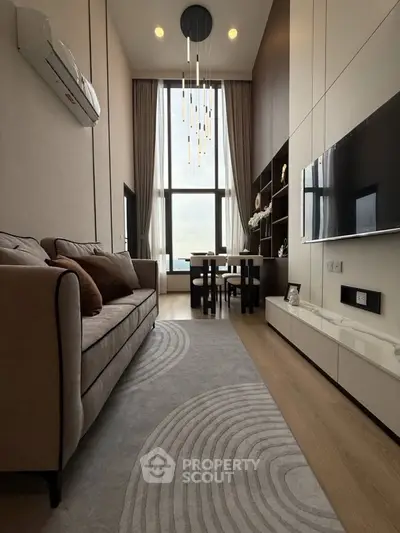 Luxurious high-ceiling living room with modern decor and large windows.