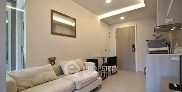 Modern living room with cozy sofa and compact dining area in stylish apartment.