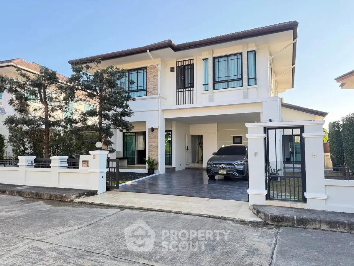 Stunning two-story modern house with spacious driveway and elegant facade.