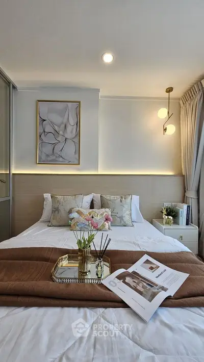 Elegant bedroom with modern decor and soft lighting, featuring a cozy bed and stylish artwork.