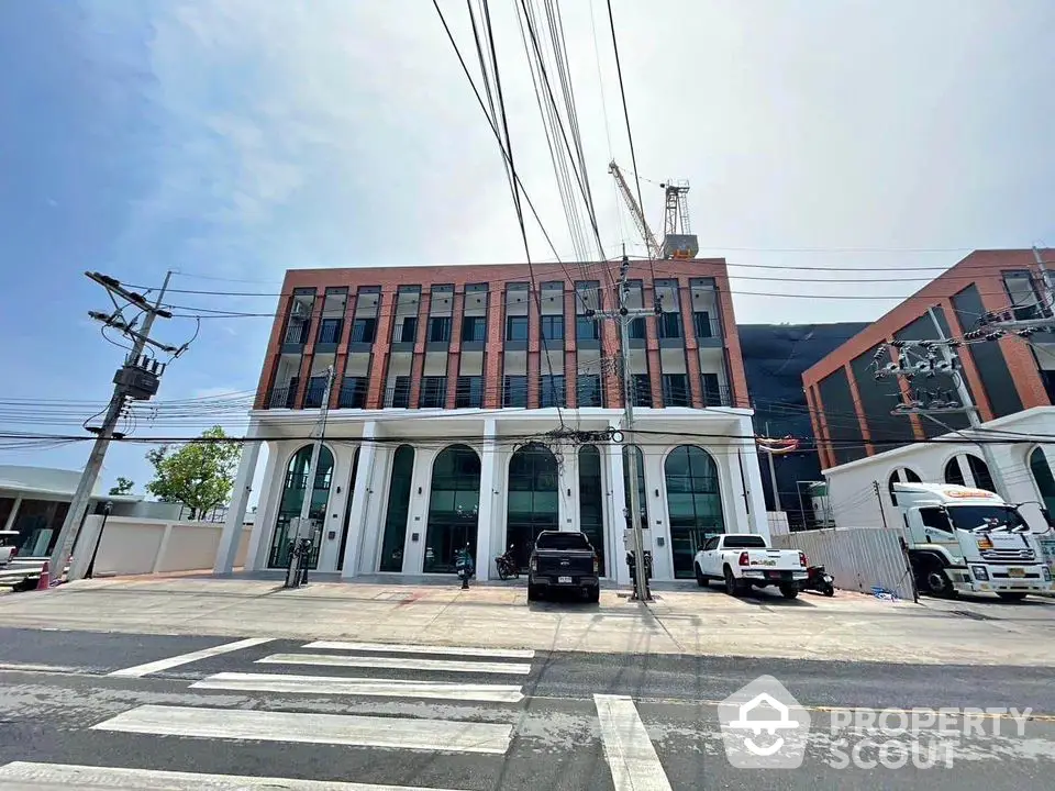 Modern commercial building with arched windows and brick facade in urban setting