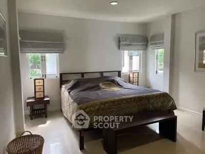 Spacious bedroom with elegant decor and natural light