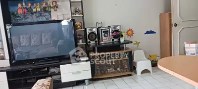 Charming living room with entertainment center and playful decor