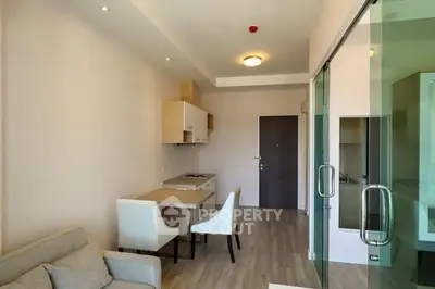 Modern open-plan living room with dining area and glass partition