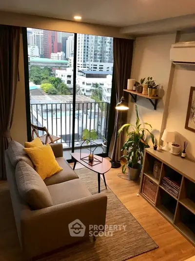 Chic living room with balcony view in modern apartment, featuring cozy decor and abundant natural light.