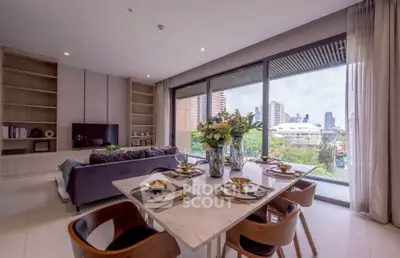 Luxurious living room with dining area and stunning city view, featuring elegant decor and large windows.