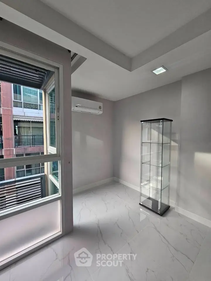 Modern minimalist room with large window and glass display cabinet