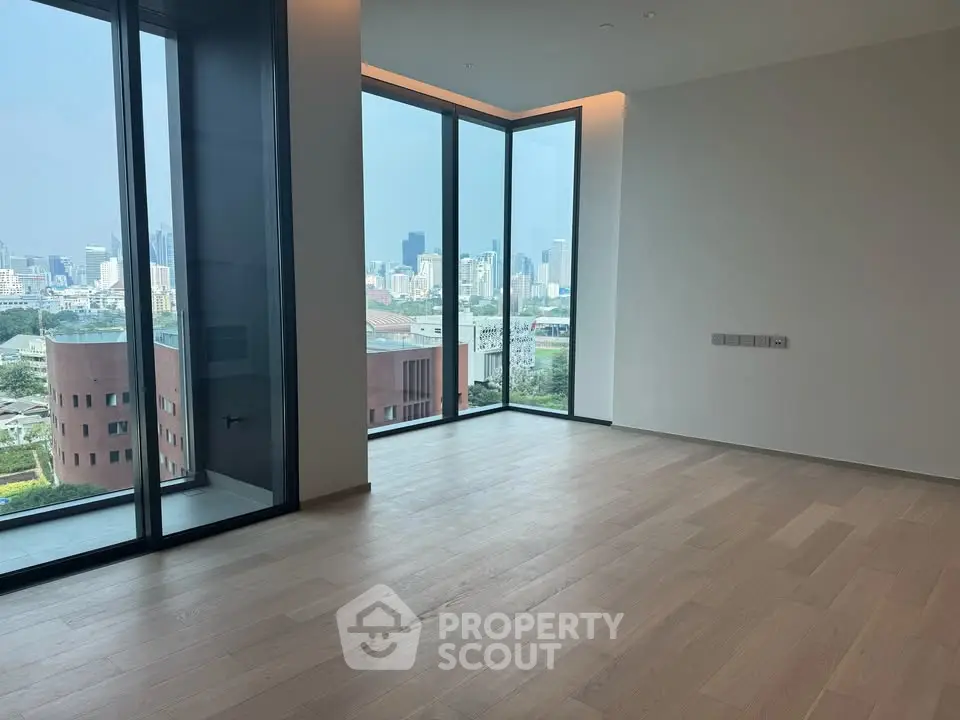 Spacious corner unit with floor-to-ceiling windows offering stunning city views and abundant natural light.