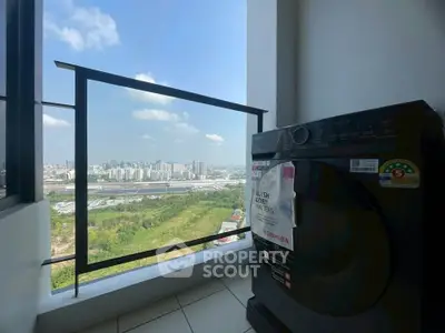 High-rise apartment with scenic city view and modern washing machine on balcony.