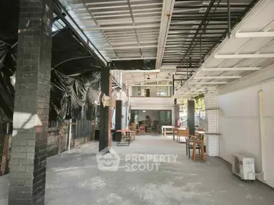 Spacious covered outdoor area with seating and industrial design elements.