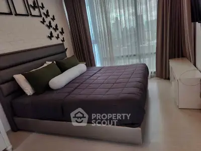 Luxurious bedroom with modern decor and city view, featuring elegant bedding and stylish wall art.