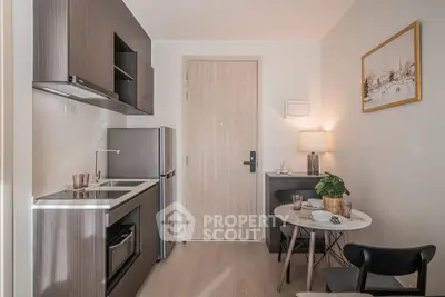 Modern compact kitchen with dining area in stylish apartment