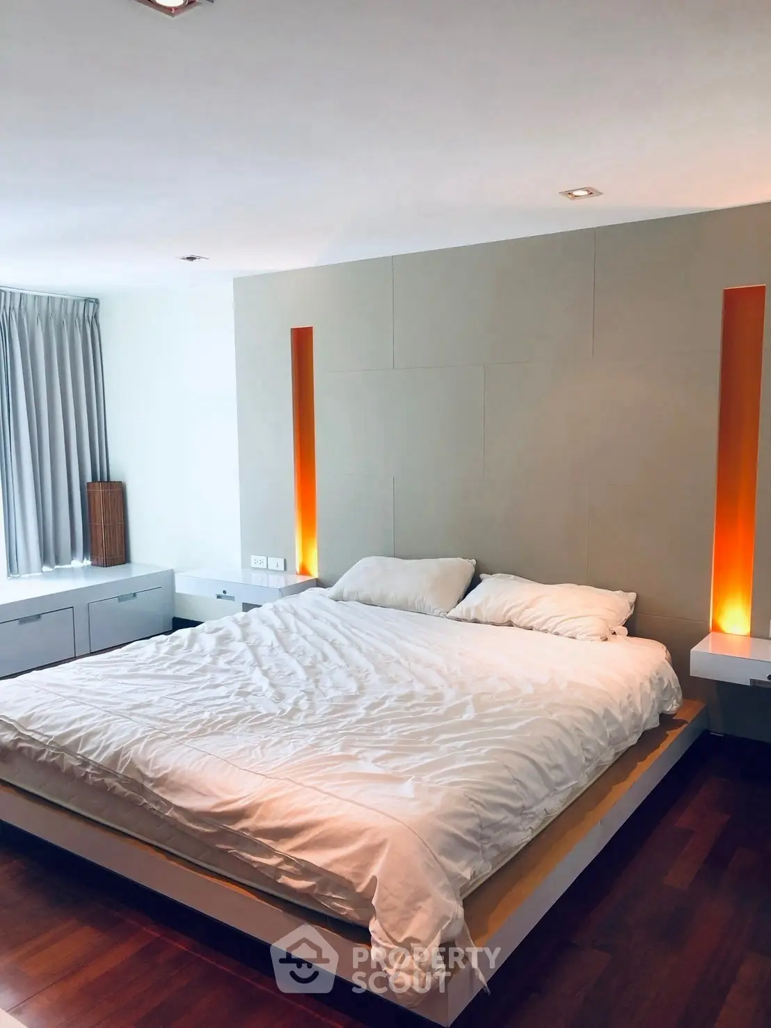 Modern bedroom with stylish lighting and wooden flooring