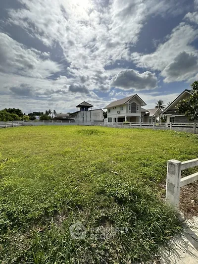 Spacious green plot with potential for development in serene neighborhood