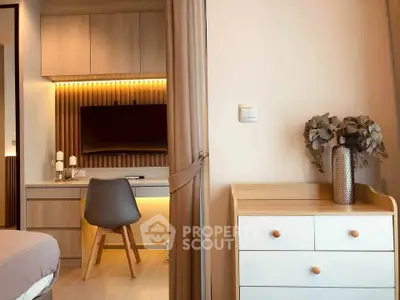 Modern bedroom with stylish desk and chair, featuring warm lighting and elegant decor.