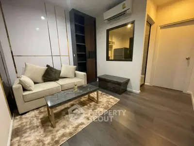 Modern living room with sleek design, featuring a cozy sofa, stylish coffee table, and elegant decor.