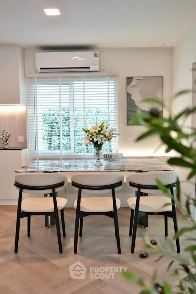 Stylish dining area with modern decor and natural light, perfect for cozy gatherings.
