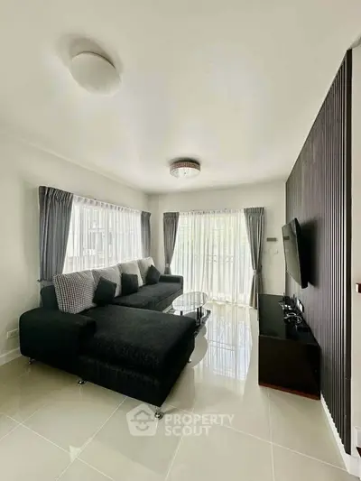 Spacious living room with modern decor and large windows for natural light.