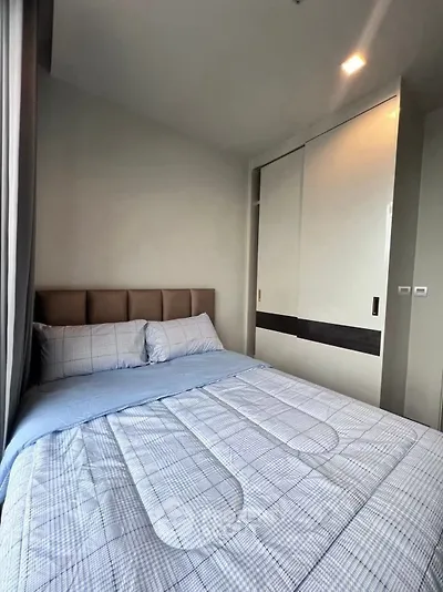 Cozy bedroom with modern design and built-in wardrobe