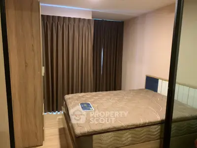 Cozy bedroom with modern furnishings and elegant curtains in a stylish apartment.