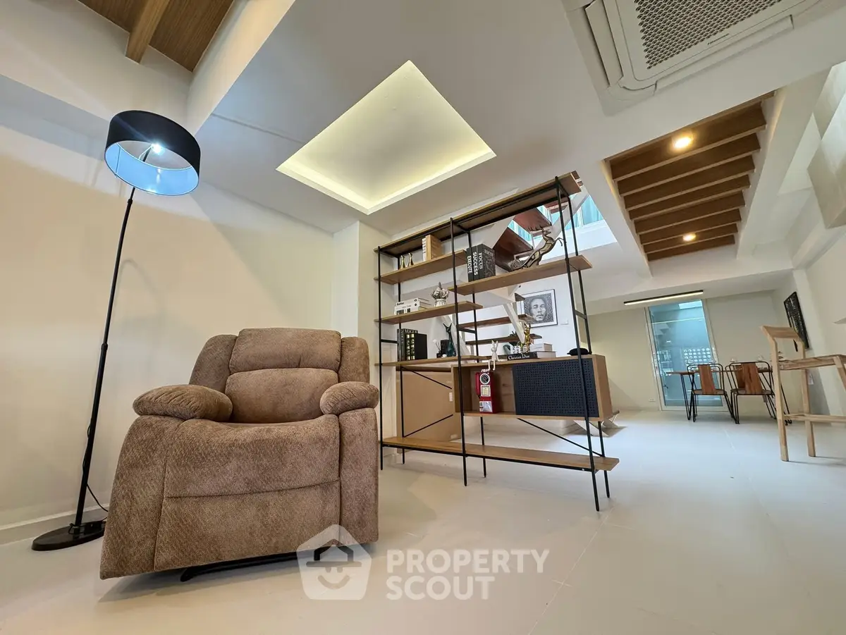 Modern living room with cozy armchair and stylish shelving unit