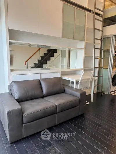 Modern loft interior with sleek black sofa and stylish workspace