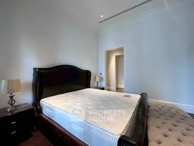 Spacious bedroom with elegant bed and stylish decor in luxury real estate property.