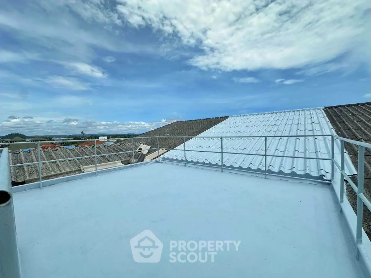 Spacious rooftop with scenic views and clear blue sky, perfect for relaxation or entertainment.