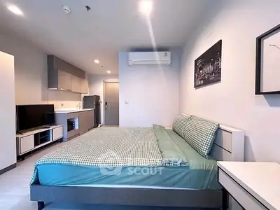 Modern studio apartment with stylish decor and compact kitchen area, perfect for urban living.