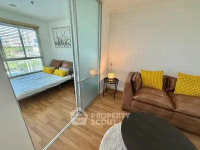 Modern apartment with cozy living room and bedroom separated by glass sliding door