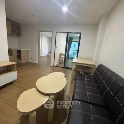 Modern living room with stylish furniture and wooden flooring in a cozy apartment.